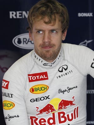 Red Bull driver Sebastian Vettel, of Germany, sits in his team's pit before a free practice at the Interlagos race track in Sao Paulo, Brazil, Friday, Nov. 23, 2012. Brazil's Formula One Grand Prix will take place Sunday.