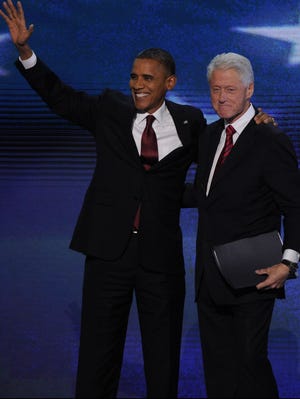 President Obama and Bill Clinton wave at the Democratic National Convention.