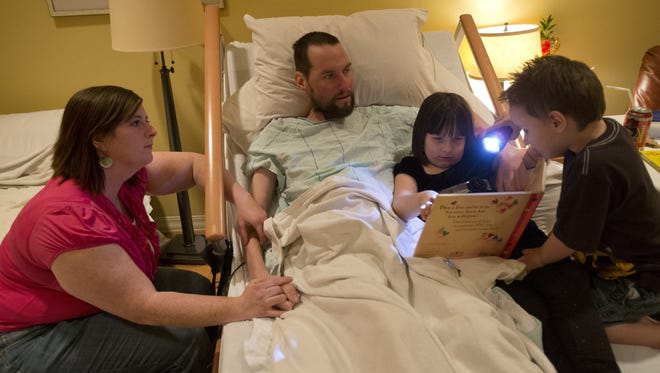 Amber and Dustin Murphy spend time with daughter Kenlie, 7, and son Branson, 3, at Hospice of the Valley in Gilbert, Ariz., on Dec. 17, 2012. Dustin is dying from stage 4 colon cancer.