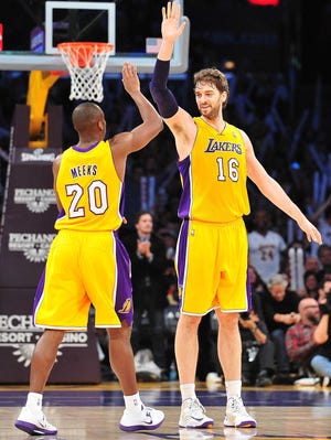 Lakers forward Pau Gasol, right, greets guard Jodie Meeks with a high-five during Friday's 104-87 win vs. the Blazers.