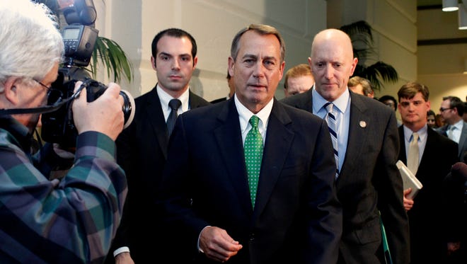 House Speaker John Boehner leaves a meeting with House Republicans on Tuesday.