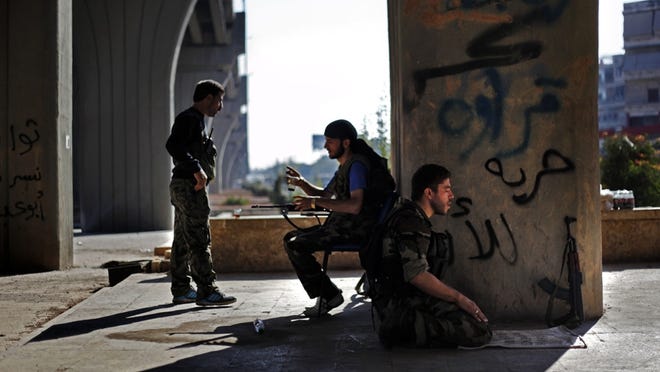 A Free Syria Army soldier prays before moving out to his designated fighting position in Aleppo city in September.