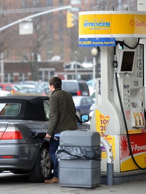 A man pumps gasoline at a Shell station on the east side of Manhattan in New York.