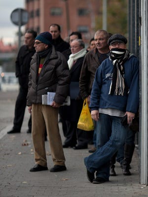 Jobseekers in Madrid in December 2012 waiting for a government jobs office to open.