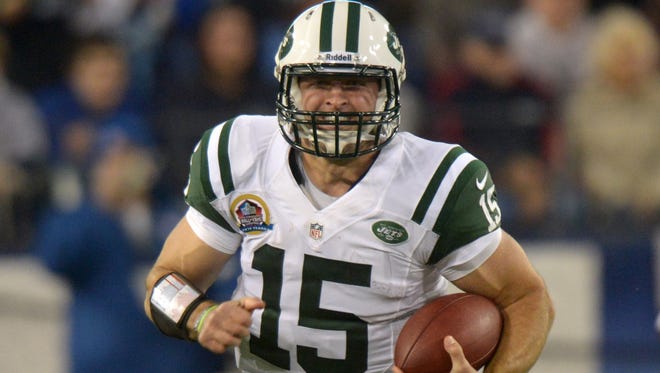 New York Jets quarterback Tim Tebow carries the ball against the Tennessee Titans at LP Field.
