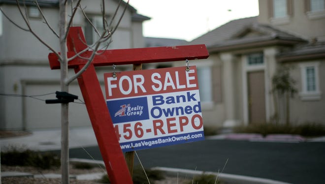 A for sale sign stands in front of a bank-owned home in Las Vegas on Feb. 8, 2008.