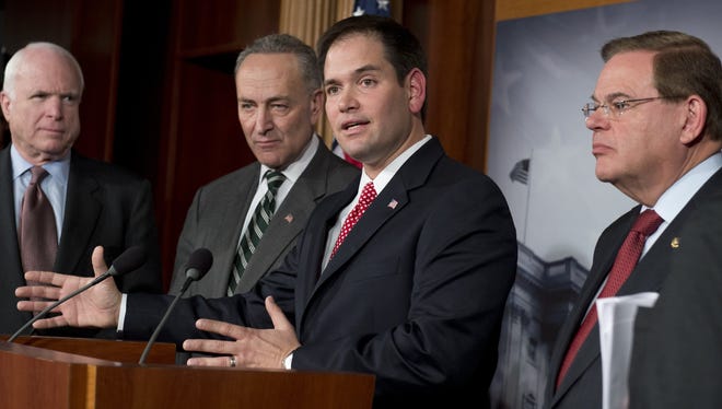 Sen. Marco Rubio, R-Fla., discusses a bipartisan immigration proposal announced on Monday as (from left) Sen. John McCain, R-Ariz., Sen. Chuck Schumer D-N.Y., and Sen. Robert Menendez, D-N.J.look on.