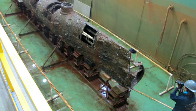 The Confederate submarine H.L. Hunley sits in a conservation tank after a steel truss that had surrounded it was removed Jan. 12, 2012, in a conservation lab in North Charleston, S.C.