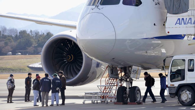 Officials inspect an All Nippon Airways Boeing 787 which made an emergency landing at Takamatsu airport in Takamatsu, western Japan, earlier this month.