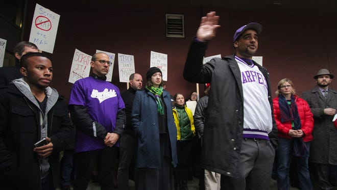 In this Jan. 23 photo, Garfield High School social studies teacher Jesse Hagopian, with his hand raised, and other teachers rally to protest the Measures of Academic Progress (MAP) test outside the Seattle School District Headquarters.