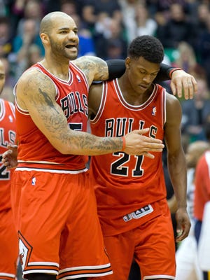 Bulls forward Carlos Boozer puts his arm around Jimmy Butler during Friday's 93-89 win vs. the Jazz.