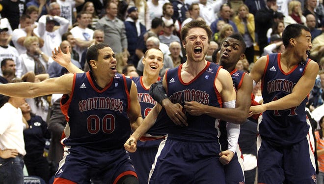 Matthew Dellavedova (4) of Saint Mary's celebrates his last-second basket with his teammates at the end of the Gaels' 70-69 win over BYU on Jan. 16.