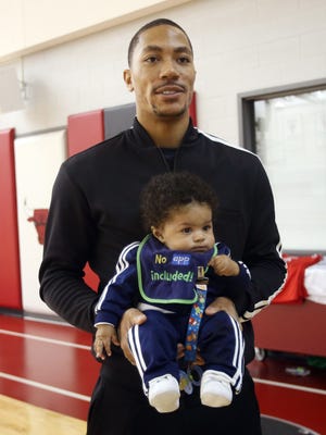 Bulls guard Derrick Rose shows off his son, Derrick "P.J." Rose Jr., during a workout session Feb. 11.