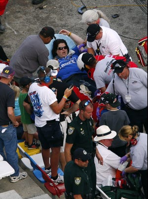 A fan is treated for injuries sustained from debris that went into the stands following a crash on the last lap of Saturday's DRIVE4COPD 300 Nationwide race at Daytona International Speedway.