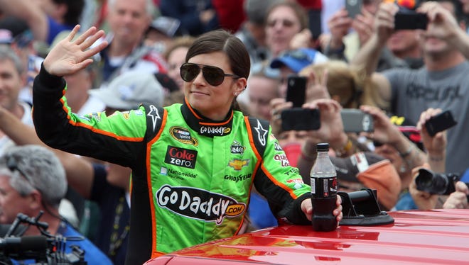 NASCAR Sprint Cup Series driver Danica Patrick waves to the crowd as she is introduced before the 2013 Daytona 500 at Daytona International Speedway.