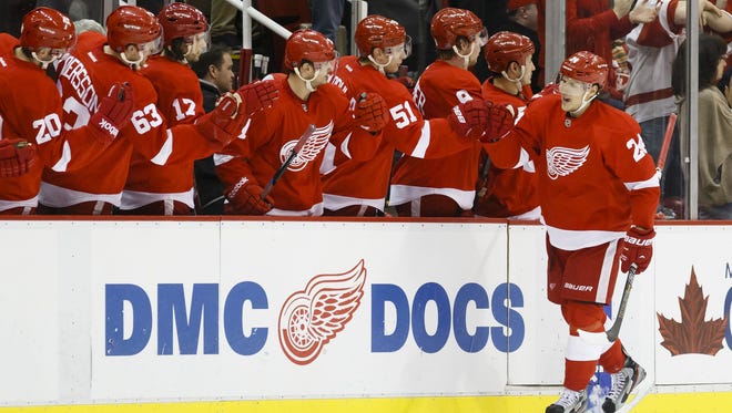 Detroit Red Wings center Damien Brunner receives congratulations from teammates after scoring a goal during the second period against the Vancouver Canucks at Joe Louis Arena.