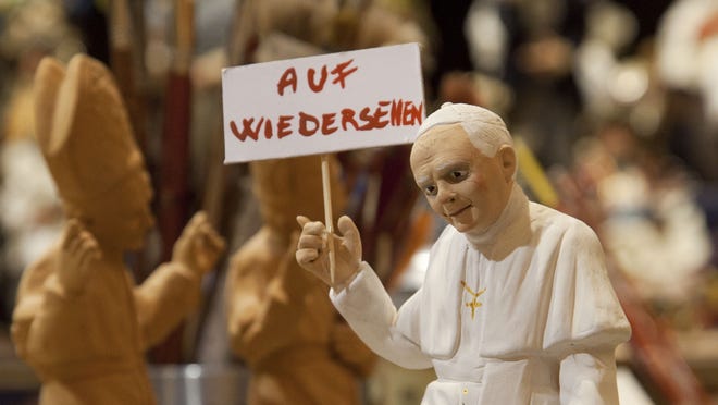 A figurine depicting Pope Benedict XVI holding a placard reading in German 'Goodbye' is displayed in the shop of craftman Gennaro Di Virgilio in Via San Gregorio Armeno, Italy.