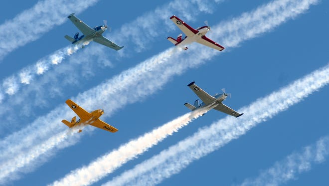 Various warbirds fly in formation during the airshow at EAA AirVenture 2011 in Oshkosh.