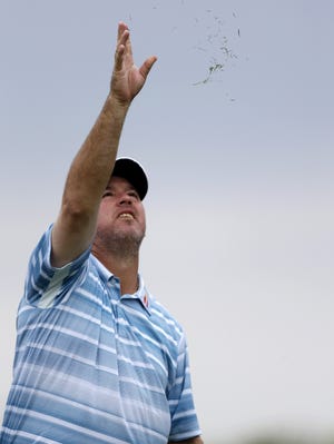 Boo Weekley checks the wind on his way to a first-round 66 at the Honda Classic.