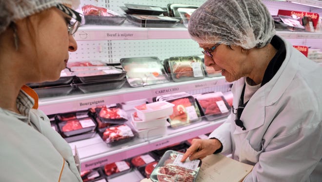 Employees conduct a verification of the origin of the meat in a supermarket in eastern France on Friday.