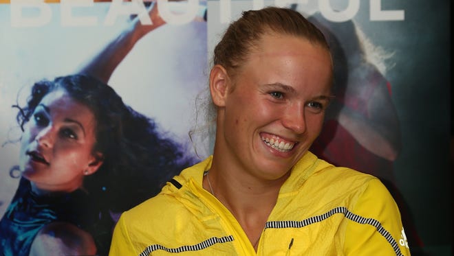 Caroline Wozniacki, shown here at a news conference, says she's not totally clear on the medical timeout rule. "I don't exactly know the rules there to be honest," the Dane said. "Are you allowed to have two treatments on two injuries in one changeover? Is that what it is?"