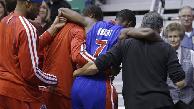 Detroit Pistons' Brandon Knight (7) is helped off the court after being injured against the Utah Jazz on Monday.