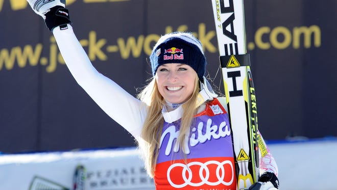 In this Jan. 19 file photo, Lindsey Vonn, of the United States, celebrates at the finish area after winning an Alpine Ski World Cup women's downhill, in Cortina D'Ampezzo, Italy.  Vonn has won her sixth straight World Cup downhill title after thick fog forced the scheduled final race to be cancelled on Wednesday.