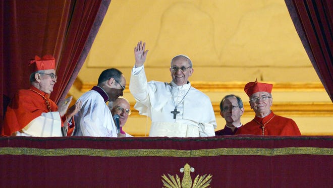 Argentina's Jorge Bergoglio, elected Pope Francis waves from the window of St. Peter's Basilica's balcony after being elected the 266th pope of the Roman Catholic Church.