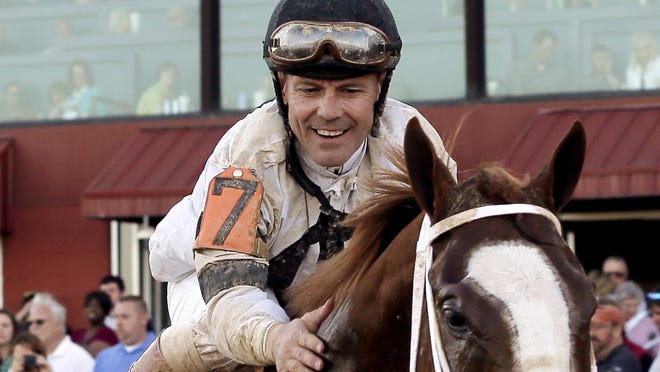 Jockey Jon Court gives Will Take Charge a pat on the neck after winning the $600,000 Rebel Stakes at Oaklawn Park in Hot Springs, Ark., Saturday
