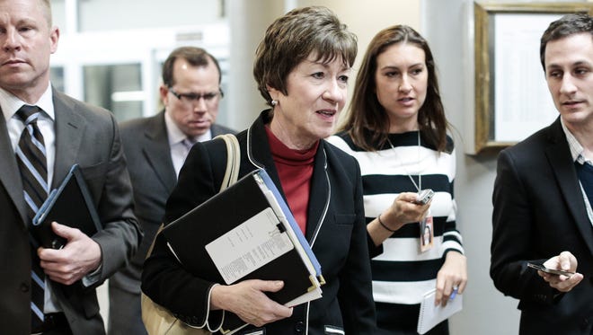 Sen. Susan Collins, R-Maine, center, talks to reporters on Capitol Hill.