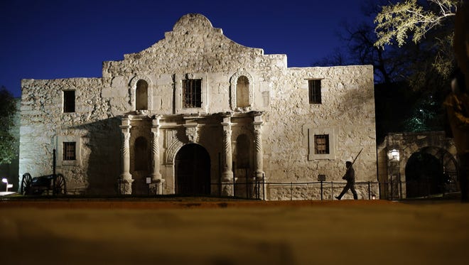 John Potter, a member of the San Antonio Living History Association, patrols the Alamo during a pre-dawn memorial ceremony to remember the 1836 Battle of the Alamo and those who fell on both sides, March 6, in San Antonio.