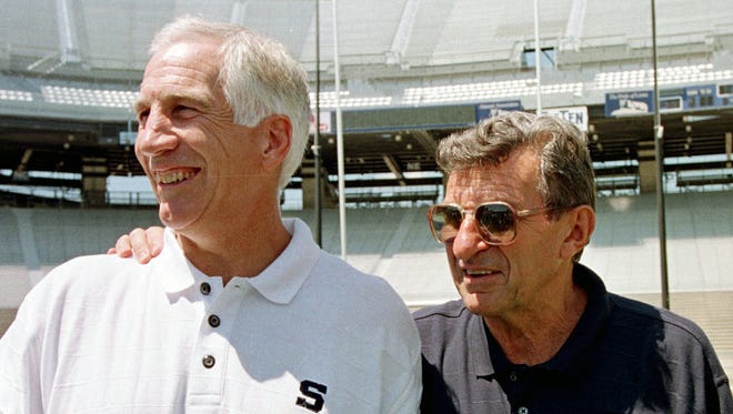 Penn State football coach Joe Paterno, right, poses with his defensive coordinator, Jerry Sandusky, in 1999 during the college football team's media day in State College, Pa.