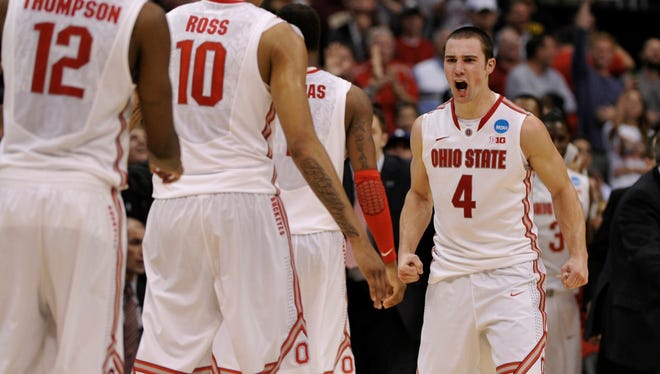 Ohio State Buckeyes guard Aaron Craft congratulates forward LaQuinton Ross for making the game-winning basket against the Arizona Wildcats at Staples Center.