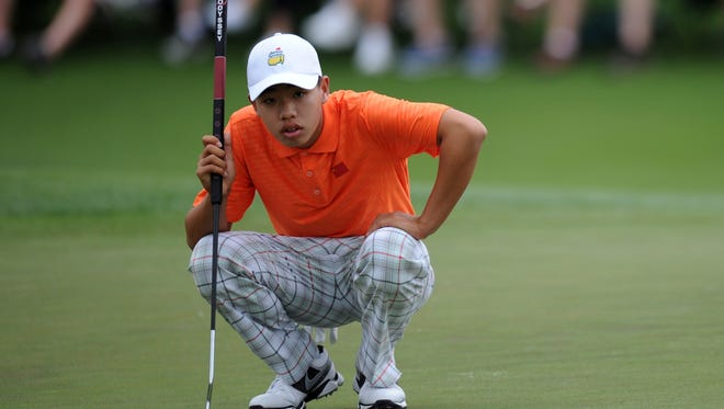China's Guan Tianlang lines up a putt during the second round of the Masters. Guan, at 14, would be eligible for the National Drive, Chip and Putt Competition, that finishes at Augusta National.