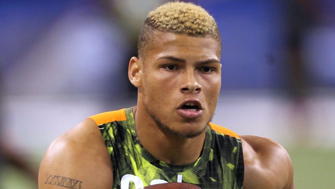 Former LSU defensive end Tyrann Mathieu runs with the ball after catching a pass during the NFL combine at Lucas Oil Stadium.