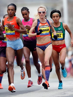 American Shalane Flanagen (third from left) runs with Rita Jeptoo of Kenya near the 19 mile marker during the 2013 Boston Marathon. Jeptoo won in 2:26:25. Flanagan was fourth in 2:27:08.