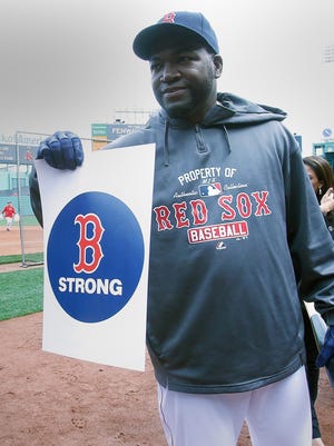David Ortiz posts with a "Boston Strong" sign, which honors the Marathon bombing victim before the game.