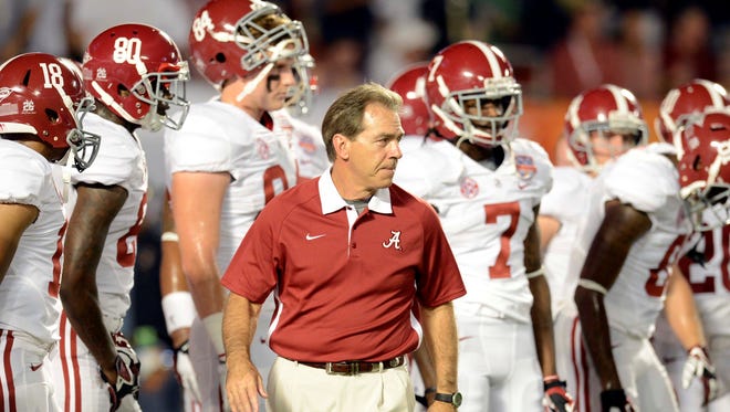 Alabama coach Nick Saban leads his team to the field before the 2013 BCS Championship game against Notre Dame.