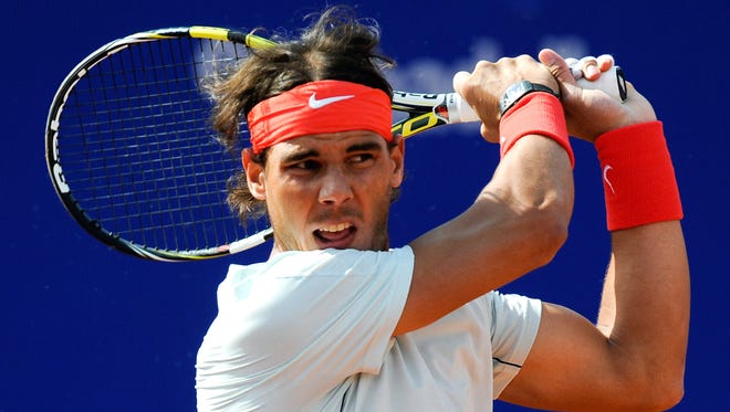 Rafael Nadal of Spain follows through on a backhand during his victory Friday against Benoit Paire of France.