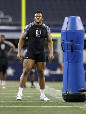 British Olympian Lawrence Okoye prepares to run a defensive end position drill during an NFL combine this month in Arlington, Texas. Undrafted, he has agreed to play for the San Francisco 49ers.