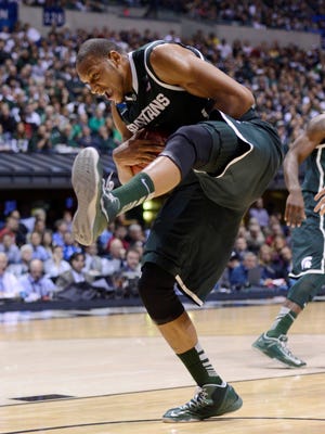 Michigan State Spartans forward Adreian Payne reacts as he pulls in a rebound against the Duke Blue Devils during the semifinals of the Midwest regional of the 2013 NCAA tournament. Payne announced he will return to school for his senior year.