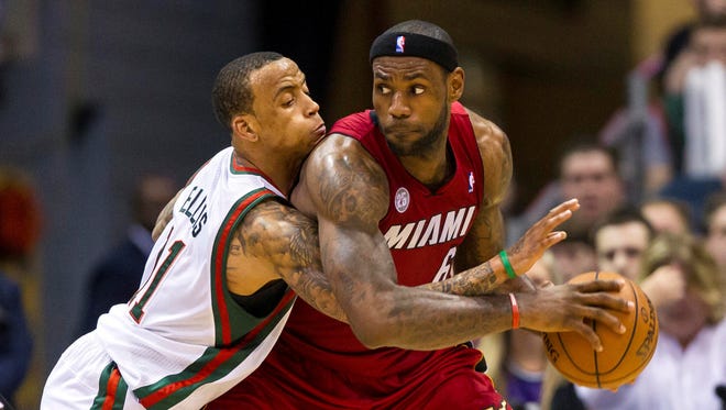 Heat forward LeBron James posts up on Bucks guard Monta Ellis during Game 4 Sunday.