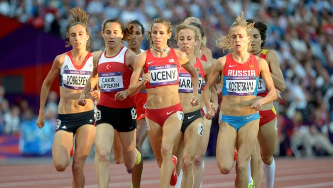 Asli Cakir Alpetkin of Turkey runs next to American Morgan Uceny in the women's 1,500 semifinal during the London 2012 Olympic Games at Olympic Stadium on Aug. 8.