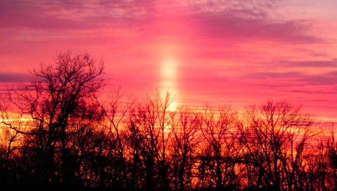 Indiana sun pillar: A sun pillar appears at sunset in Vincennes, Ind., in January. Sun pillars form above or below the sun and are caused by sunlight reflecting off ice crystals.