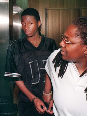 Malcolm Shabazz,14, is led in handcuffs from Family Court in Yonkers, N.Y., on July 29, 1999.