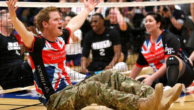 Prince Harry gets enthusiastic about playing sitting volleyball with the British  team at the Warrior Games at the U.S. Olympic Training Center in Colorado Springs.
