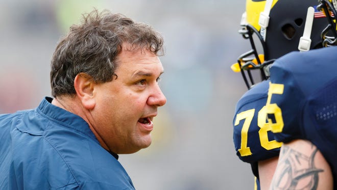 Michigan coach Brady Hoke talks to offensive linesman Erik Magnuson (78) during the Wolverines' spring game at Michigan Stadium. Hoke joked about Notre Dame ending its football series with the Wolverines in a speech this week.