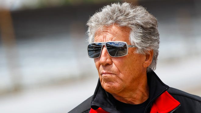 Mario Andretti watches the action from pit lane during Indianapolis 500 practice at the Indianapolis Motor Speedway.