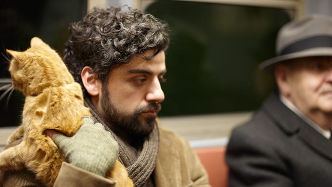 Oscar Isaac holds onto his cat co-star in a scene from 'Inside Llewyn Davis.'