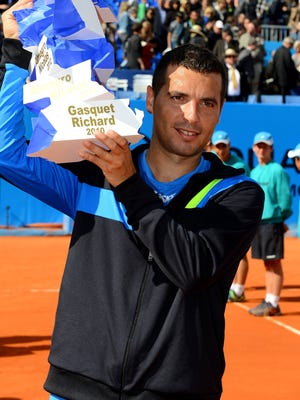 Spanish player Albert Montanes holds his trophy after winning the final of the Nice Cote d'Azur open tournament.